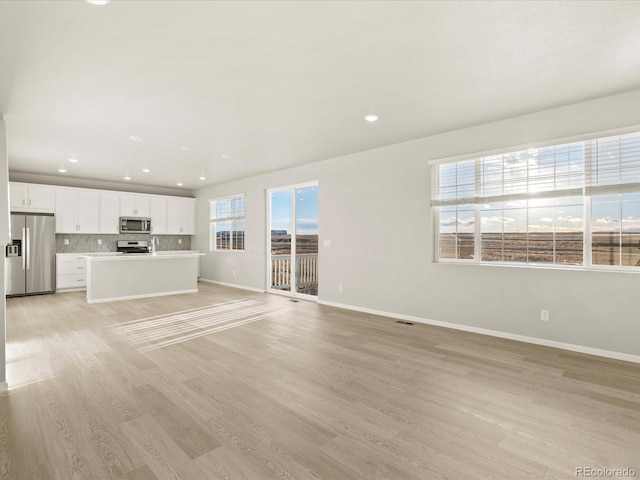 unfurnished living room with light wood-type flooring