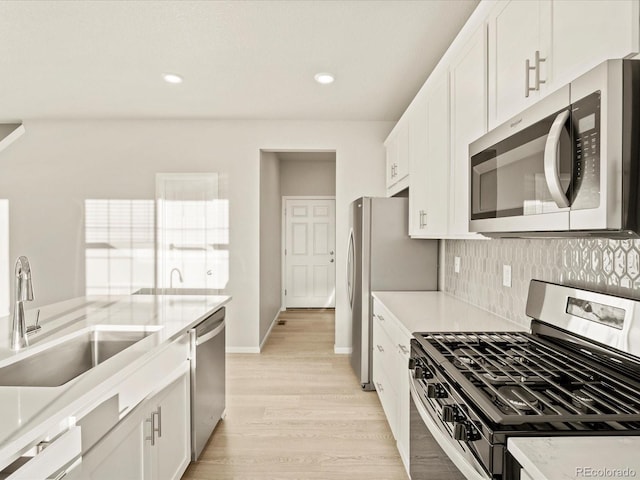 kitchen featuring sink, white cabinetry, and stainless steel appliances