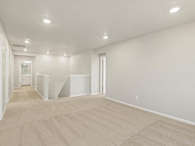 spare room with light colored carpet