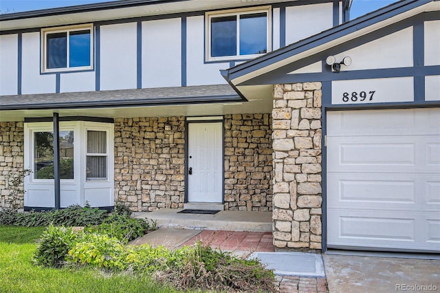 8897 Wagner Ln, Westminster, CO 80031 - view of exterior entry featuring stone siding, stucco siding, and a shingled roof