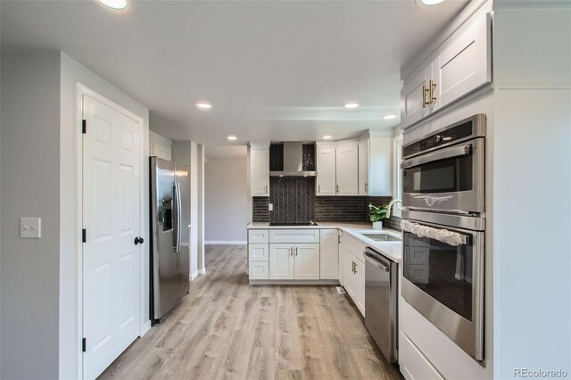 8897 Wagner Ln, Westminster, CO 80031 - kitchen featuring stainless steel appliances, decorative backsplash, recessed lighting, light wood-type flooring, and white cabinetry