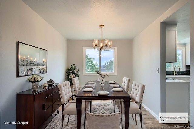 8897 Wagner Ln, Westminster, CO 80031 - dining area featuring a chandelier and light wood-type flooring