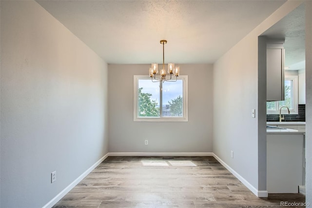 8897 Wagner Ln, Westminster, CO 80031 - unfurnished dining area featuring a chandelier and light wood finished floors