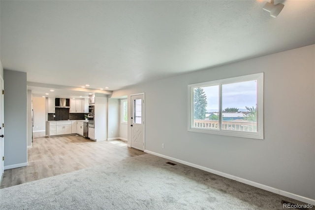 8897 Wagner Ln, Westminster, CO 80031 - unfurnished living room featuring light colored carpet and recessed lighting