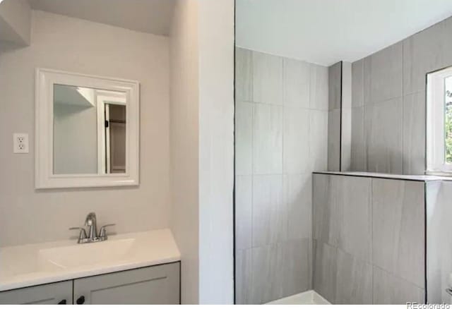 8897 Wagner Ln, Westminster, CO 80031 - bathroom featuring vanity and a tile shower