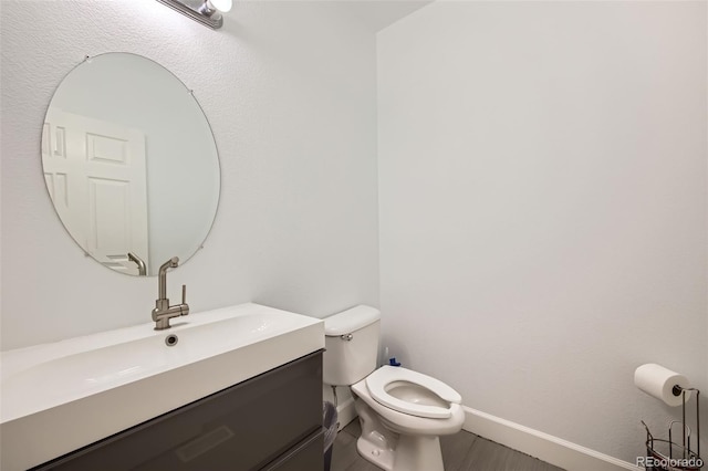 bathroom with vanity, hardwood / wood-style floors, and toilet