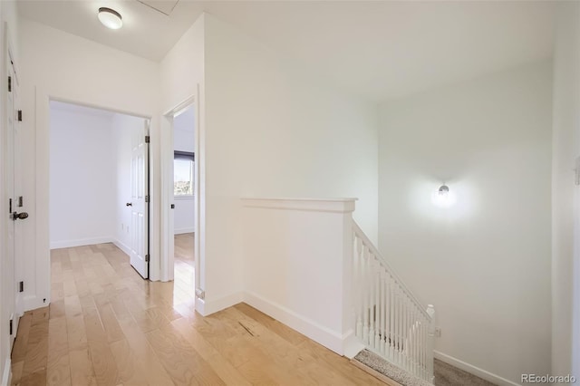 hallway with light hardwood / wood-style floors