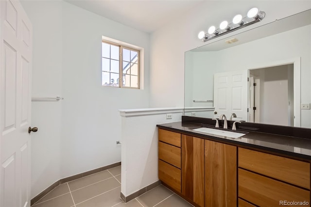 bathroom with tile patterned flooring and vanity