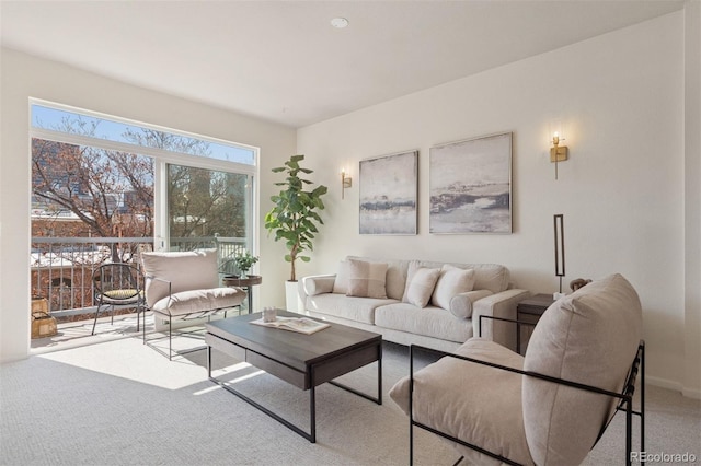 carpeted living area featuring baseboards