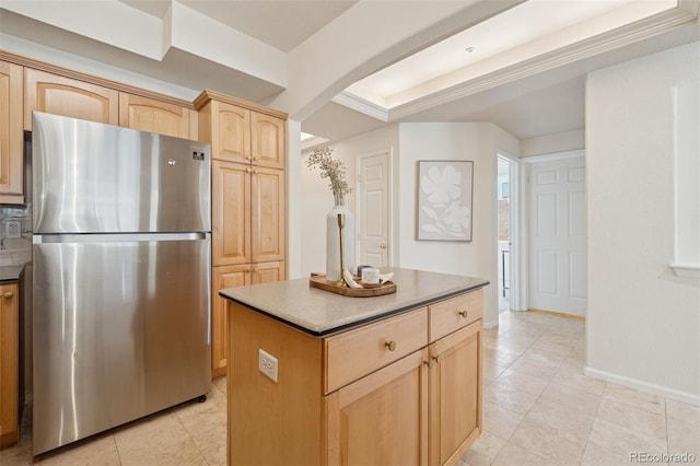 kitchen with freestanding refrigerator, light brown cabinetry, arched walkways, a center island, and baseboards