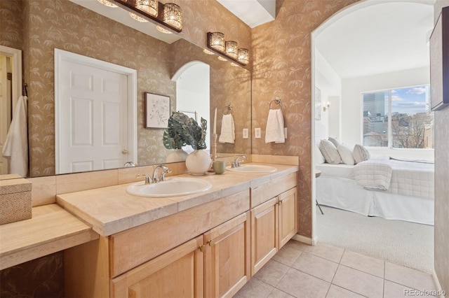 full bathroom featuring wallpapered walls, connected bathroom, tile patterned flooring, and double vanity