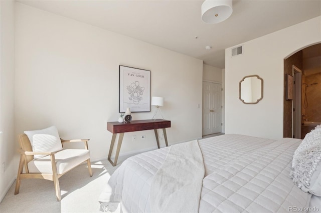 bedroom featuring arched walkways, carpet flooring, and baseboards