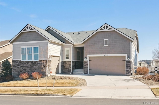 craftsman inspired home featuring driveway and stone siding