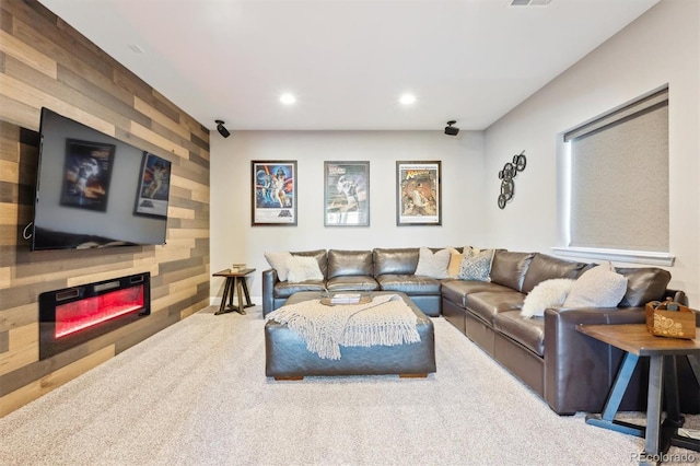 living area with recessed lighting, a large fireplace, carpet floors, wood walls, and baseboards