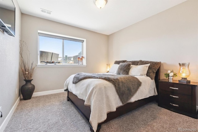 carpeted bedroom with visible vents and baseboards