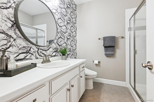 full bath with a stall shower, baseboards, toilet, tile patterned flooring, and vanity