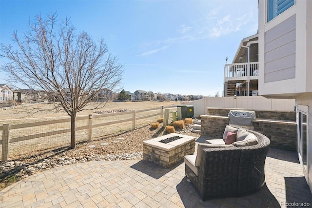 view of patio with an outdoor fire pit, a fenced backyard, and grilling area