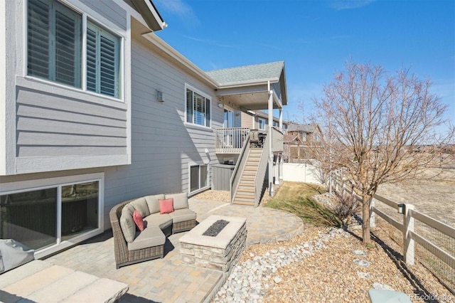 view of patio / terrace with a fenced backyard, stairs, and an outdoor living space with a fire pit