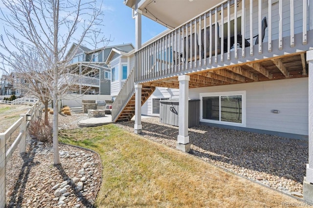 exterior space featuring fence, stairway, and a wooden deck