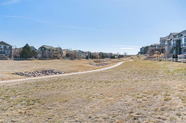 view of yard featuring a residential view and fence