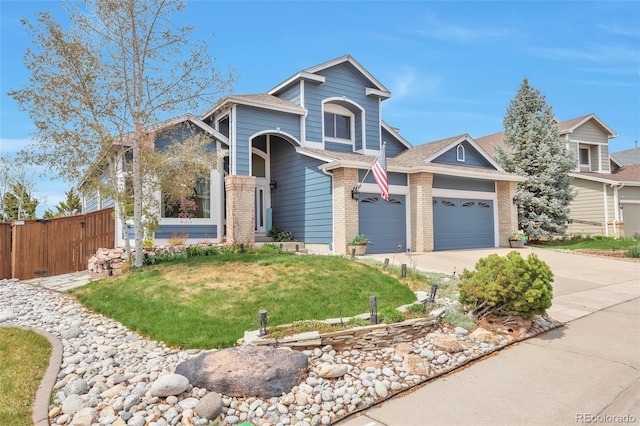 9371 Desert Willow Trl, Highlands Ranch, CO 80129 - view of front of house featuring brick siding, concrete driveway, a shingled roof, and a garage