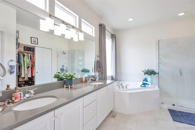 9371 Desert Willow Trl, Highlands Ranch, CO 80129 - full bath with tile patterned flooring, a shower stall, a bath, double vanity, and a walk in closet