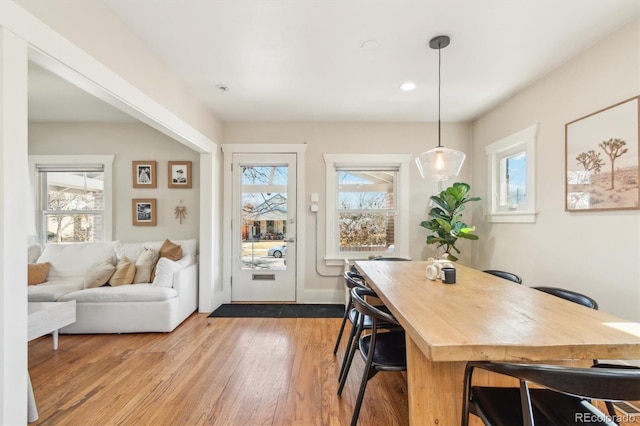 dining area with a wealth of natural light, baseboards, light wood finished floors, and recessed lighting