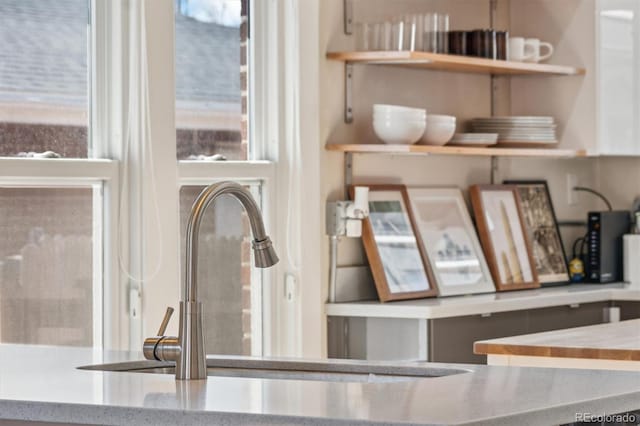 interior details featuring stone countertops and a sink