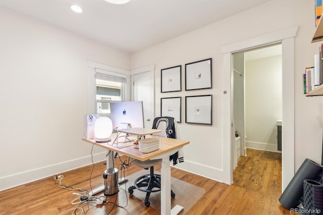 home office featuring light wood-style floors, recessed lighting, and baseboards