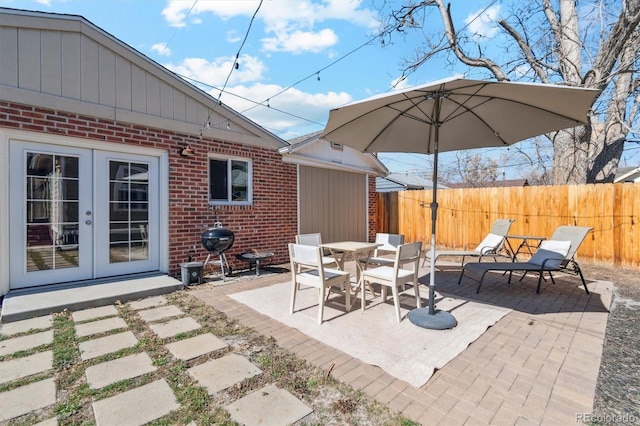 view of patio / terrace with french doors and fence