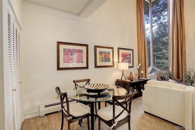 dining room featuring light wood-type flooring and a baseboard radiator