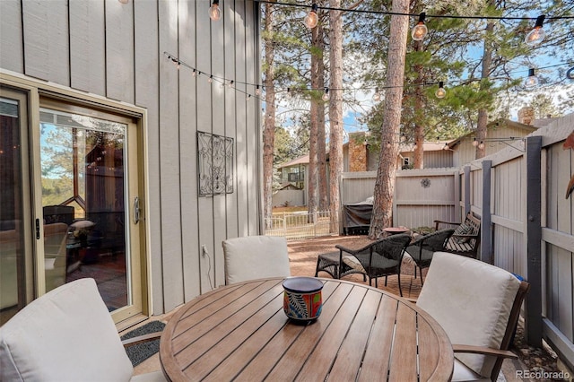 exterior space featuring outdoor dining space and a fenced backyard