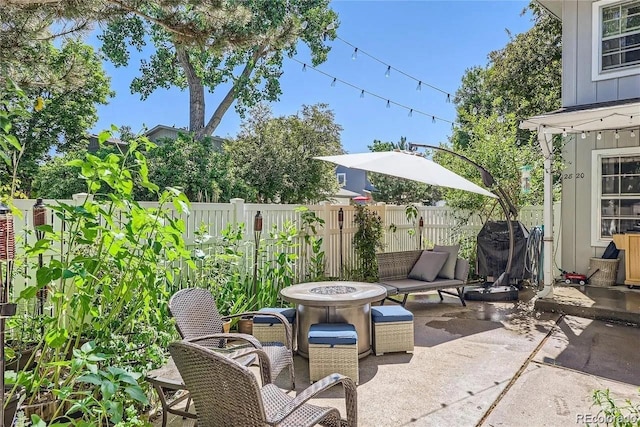 view of patio / terrace with area for grilling and a fire pit