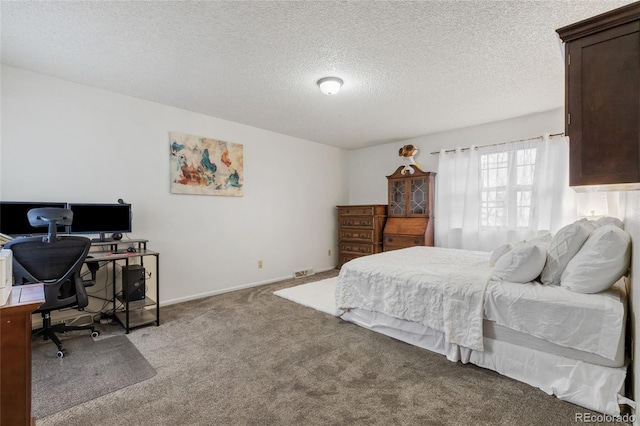 carpeted bedroom featuring a textured ceiling