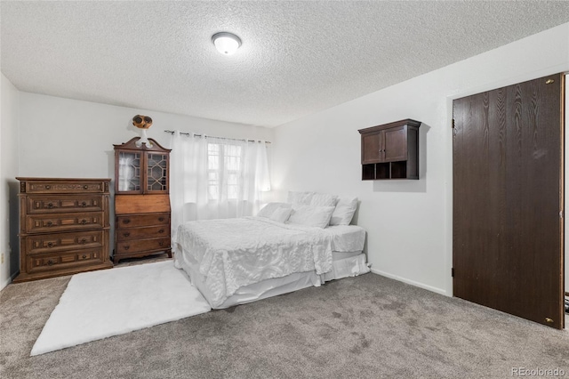 bedroom featuring carpet and a textured ceiling