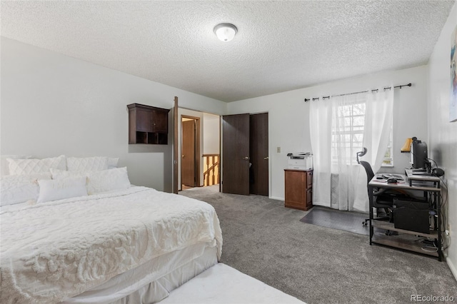 bedroom featuring carpet flooring and a textured ceiling