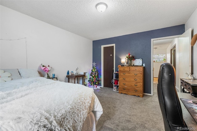 bedroom featuring carpet and a textured ceiling