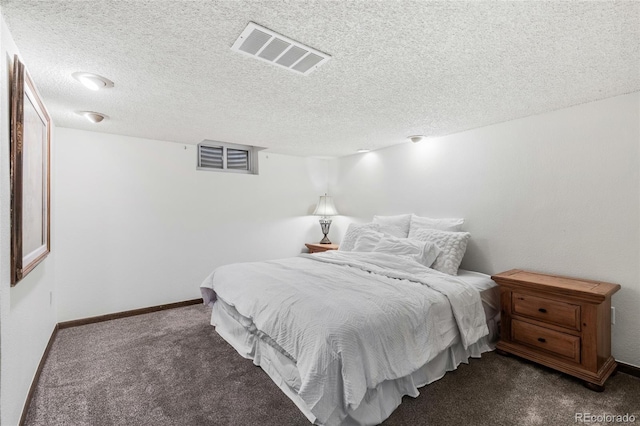 carpeted bedroom with a textured ceiling