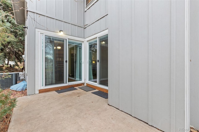 property entrance with a patio and central air condition unit