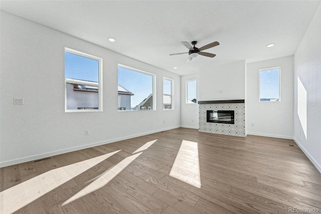 unfurnished living room with light hardwood / wood-style flooring and ceiling fan