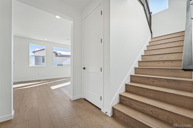 stairs featuring hardwood / wood-style flooring