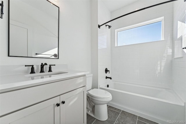 full bathroom with tile patterned floors, toilet, vanity, and tiled shower / bath