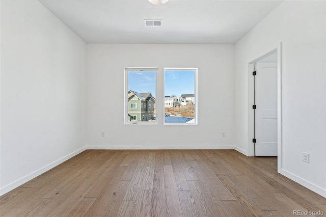 spare room with light wood-type flooring