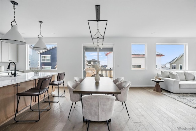 dining room with baseboards and wood finished floors