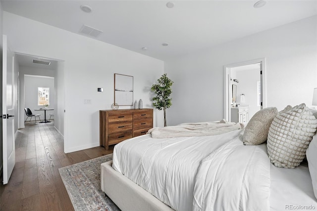 bedroom featuring hardwood / wood-style flooring, baseboards, and visible vents