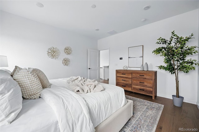 bedroom with baseboards and wood finished floors