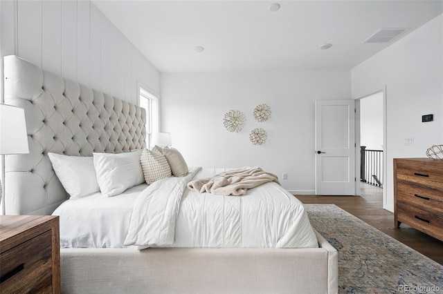 bedroom with wood finished floors and visible vents