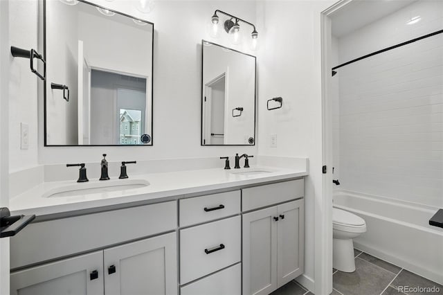 full bath featuring a sink, shower / bathtub combination, toilet, and double vanity