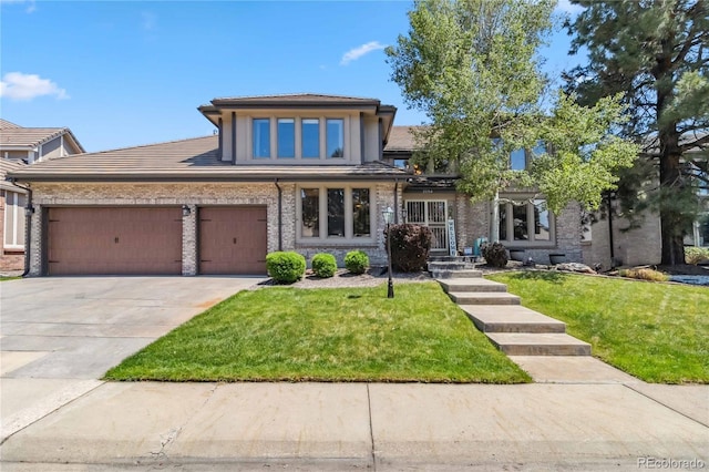 2154 S Parfet Dr, Lakewood, CO 80227 - view of front of home with a front yard, concrete driveway, an attached garage, and a tile roof