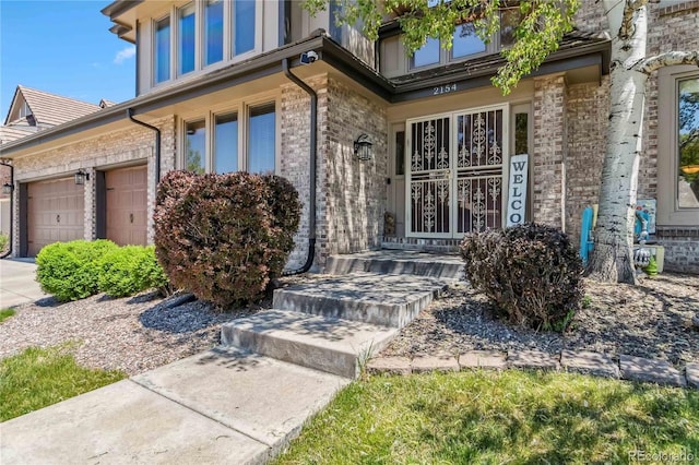 2154 S Parfet Dr, Lakewood, CO 80227 - view of exterior entry with brick siding and an attached garage